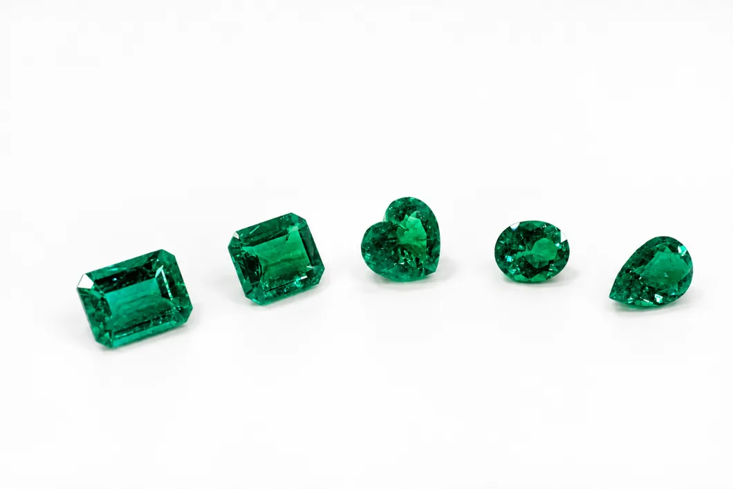 Five emeralds in different cuts